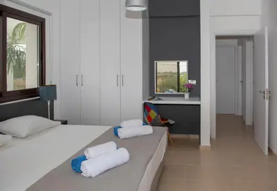 a bedroom with two beds with towels on them at Villa Fortuna in Ayia Napa