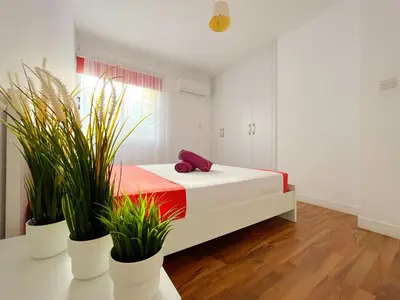 a bedroom with a bed with plants on it at Central 2 Bedroom Apt Terrace and Pool in Ayia Napa