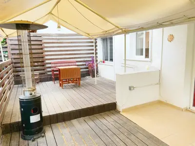 a deck with a table and a tent at Central 2 Bedroom Apt Terrace and Pool in Ayia Napa