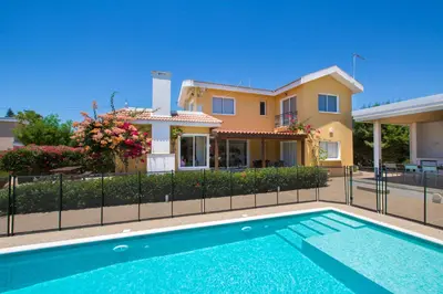 a house with a swimming pool in front of a house at Ayia Napa Villa Danae in Ayia Napa