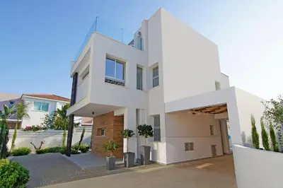 a large white house with a driveway at Villa Lily in Protaras