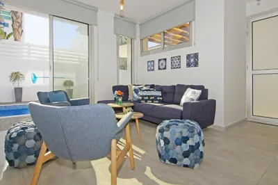 a living room with a couch and chairs at Villa Lily in Protaras