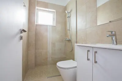 a bathroom with a shower and a toilet and a sink at Olivine Pearl Villas in Protaras