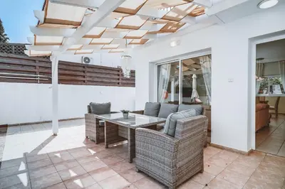 a living room with a table and chairs at Amphitrite Villa in Paralimni