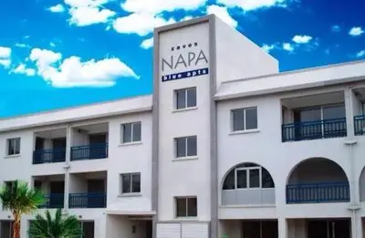 a large white building with a sign on it at Napa Blue Apartment, XXL Pool,in Hearth of Ayia Napa in Ayia Napa