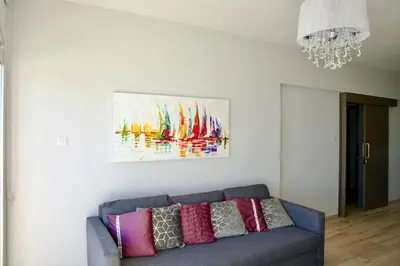 a living room with a couch and a painting on the wall at Galatex Sea Breeze in Limassol