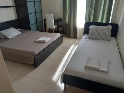 a bedroom with two beds with towels on them at Saint John Sia house in Nicosia