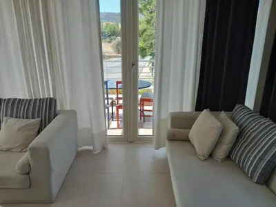 a living room with a couch and a balcony at Saint John Sia house in Nicosia
