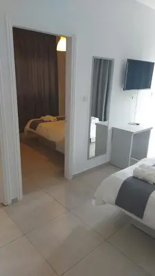 a bedroom with a bed and a mirror in it at La Veranda Hotel in Larnaka