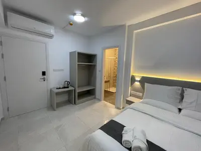 a bedroom with a large white bed and a closet at La Veranda Hotel in Larnaka