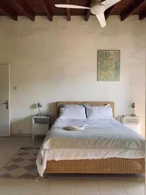 a bedroom with a large bed with two night stands at The Goathouse in Larnaka