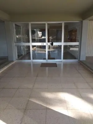 an empty room with glass doors in a building at Seaside Spacious Apartment with Sea View in Limassol