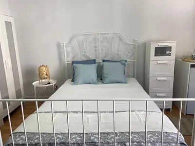a bedroom with a white bed with blue pillows at Unique Studios Phaneromenis 41 - Down Town Nicosia in Nicosia