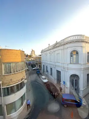 a city street with cars parked in front of a building at Unique Studios Phaneromenis 41 - Down Town Nicosia in Nicosia