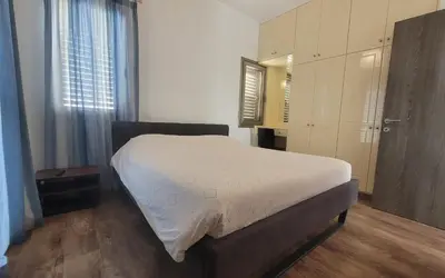 a bedroom with a bed and a dresser at Poros 2 Villa in Protaras