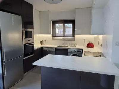 a kitchen with a white counter top and a refrigerator at Poros 2 Villa in Protaras