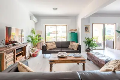 a living room with a couch and a coffee table at Sun city apartment in Limassol