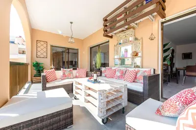 a living room with couches and a table at Sun city apartment in Limassol