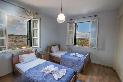 a room with two beds and two windows at Villa Joy in Protaras