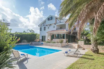 a villa with a swimming pool and a house at Villa Joy in Protaras