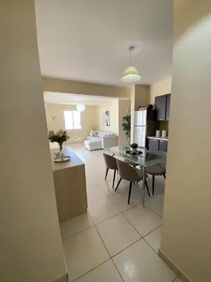 a kitchen and living room with a table and chairs at Pyla Palms A1 204 in Pyla