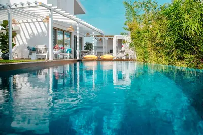 a swimming pool in front of a house at Island Home Seaside Villa in Paralimni