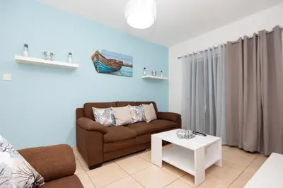 a living room with a couch and a table at Olympia flat 201 in Larnaka