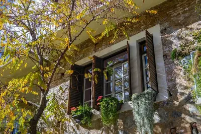 a window of a house with flowers on it at Tina's Country Home in Askas