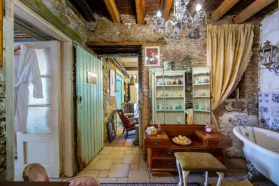 a bathroom with a sink and a desk and a tub at Tina's Country Home in Askas