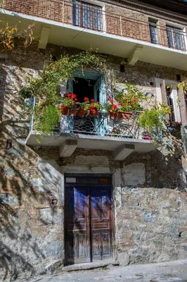 a building with a window with flowers on a balcony at Tina's Country Home in Askas