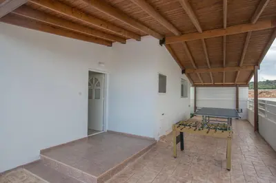 a patio with a bench and a wooden ceiling at Villa Dionysos in Protaras