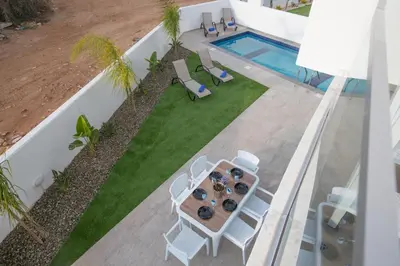 an overhead view of a patio with a table and chairs and a pool at Oli Vine Villas in Protaras