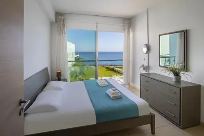 a bedroom with a bed with a view of the ocean at Coralli A 305 in Protaras