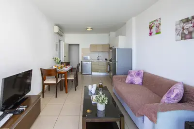 a living room with a couch and a table at Coralli A 305 in Protaras
