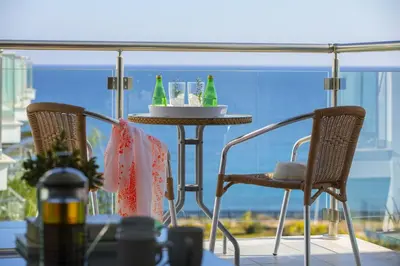 a table and chairs on a balcony with a view of the ocean at Coralli A 305 in Protaras