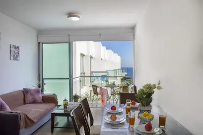 a living room with a table and a couch at Coralli A 305 in Protaras