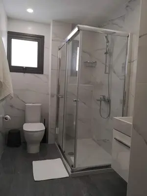 a bathroom with a shower and a toilet and a sink at Nemesis in Larnaka