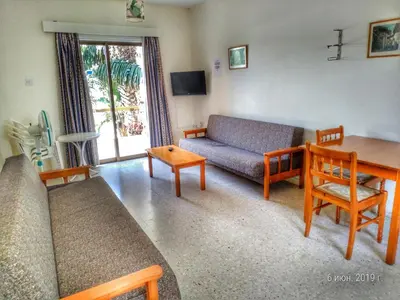 a living room with a couch and a table at Constantaras Apartments in Protaras