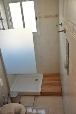 a bathroom with a shower with a toilet and a window at Raise Cosy Studio with pool in Limassol in Limassol