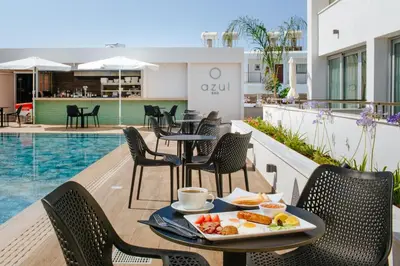 a tray of food on a table on the balcony of a hotel at Cosmo Napa Boutique Hotel in Ayia Napa