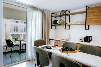 a kitchen and dining room with a table and chairs at Cosmo Napa Boutique Hotel in Ayia Napa