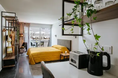 a bedroom with a bed and a living room at Cosmo Napa Boutique Hotel in Ayia Napa