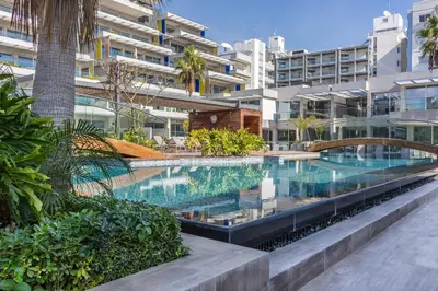 a swimming pool in the middle of a building at Carmencita Studio B14 with pool in Limassol