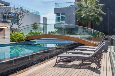 a bridge over a swimming pool in a building at Carmencita Studio B14 with pool in Limassol