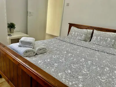 a bedroom with a large bed with towels on it at Tsimintia Apt 25 in Larnaka