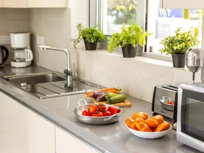 a kitchen counter with two bowls of vegetables and a sink at Villa Zoe in Protaras