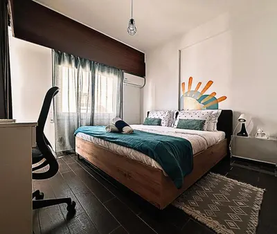 a bedroom with a large bed and a window at Youthfull Escape in Nicosia in Nicosia