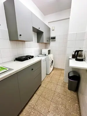 a white kitchen with a washer and dryer in it at Youthfull Escape in Nicosia in Nicosia