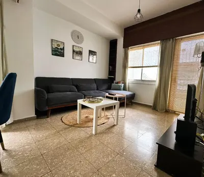 a living room with a couch and a table at Youthfull Escape in Nicosia in Nicosia
