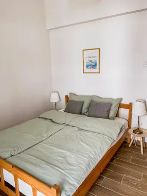 a large bed in a room with two lamps at Cozy place in Larnaka